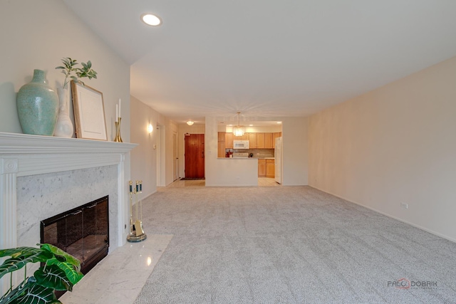 1088 Shermer Rd Unit 307, Northbrook, IL 60062 - unfurnished living room with a high end fireplace, light colored carpet, recessed lighting, and baseboards