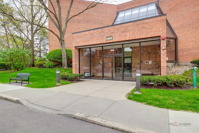 1088 Shermer Rd Unit 307, Northbrook, IL 60062 - doorway to property featuring a yard and brick siding
