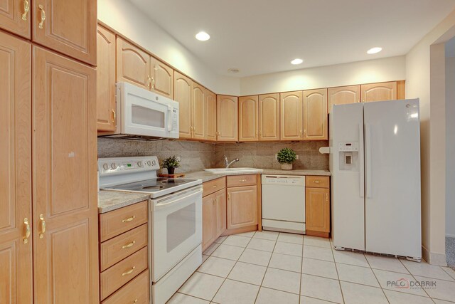 1088 Shermer Rd Unit 307, Northbrook, IL 60062 - kitchen featuring white appliances, light brown cabinetry, a sink, light tile patterned floors, and decorative backsplash
