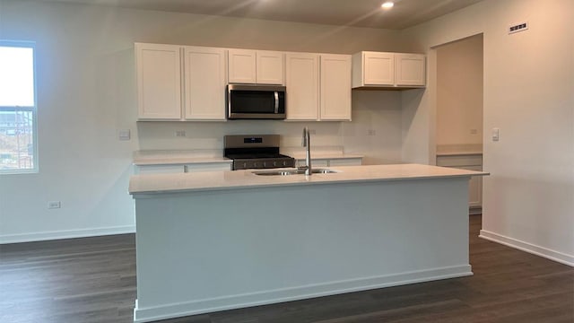 25940 S Manchester Ln, Manhattan, IL 60442 - kitchen with stainless steel appliances, white cabinets, a kitchen island with sink, dark wood-style flooring, and recessed lighting