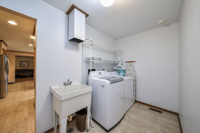 624 Joshua Ct, Naperville, IL 60540 - laundry room with washer and clothes dryer, recessed lighting, baseboards, and light wood finished floors