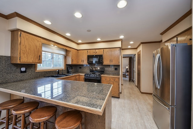 624 Joshua Ct, Naperville, IL 60540 - kitchen with black appliances, a peninsula, a sink, brown cabinetry, and light wood finished floors