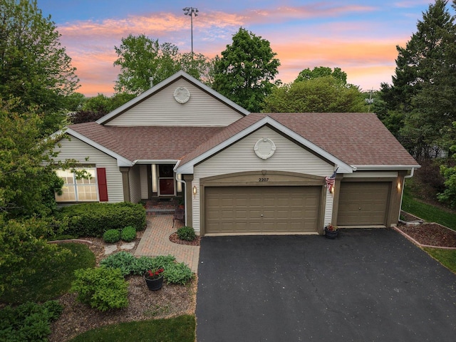 2207 Olde Mill Ln, Mchenry, IL 60050 - view of front of house with an attached garage, asphalt driveway, and a shingled roof