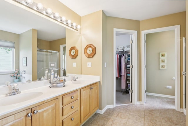 2207 Olde Mill Ln, Mchenry, IL 60050 - full bathroom with double vanity, a shower stall, a spacious closet, tile patterned flooring, and baseboards