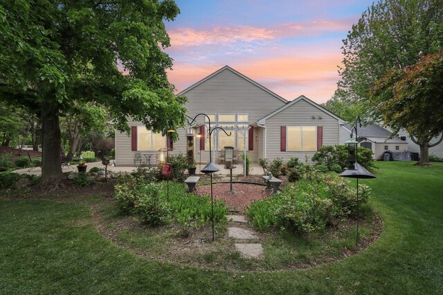 2207 Olde Mill Ln, Mchenry, IL 60050 - back of property at dusk featuring a yard