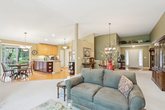 2207 Olde Mill Ln, Mchenry, IL 60050 - living area featuring a chandelier, light colored carpet, vaulted ceiling, and baseboards