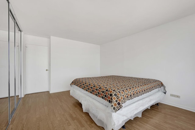 5455 N Sheridan Rd Unit 3611, Chicago, IL 60640 - bedroom with wood finished floors, baseboards, and a closet