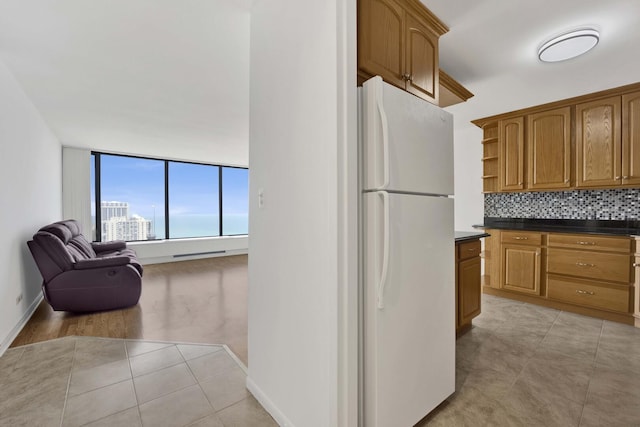 5455 N Sheridan Rd Unit 3611, Chicago, IL 60640 - kitchen featuring freestanding refrigerator, open shelves, dark countertops, open floor plan, and tasteful backsplash
