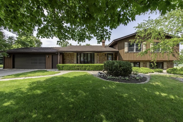 3030 Wall Ave, Waukegan, IL 60087 - tri-level home featuring an attached garage, driveway, a front yard, and a chimney
