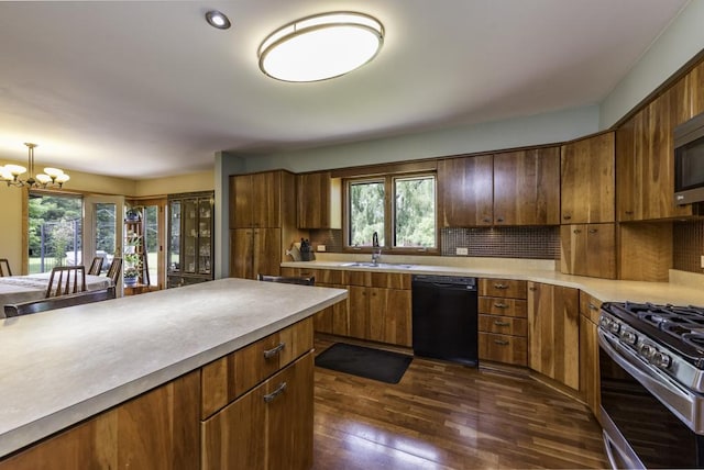 3030 Wall Ave, Waukegan, IL 60087 - kitchen with stainless steel appliances, plenty of natural light, dark wood finished floors, and light countertops