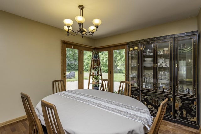 3030 Wall Ave, Waukegan, IL 60087 - dining space featuring a chandelier, wood finished floors, and french doors
