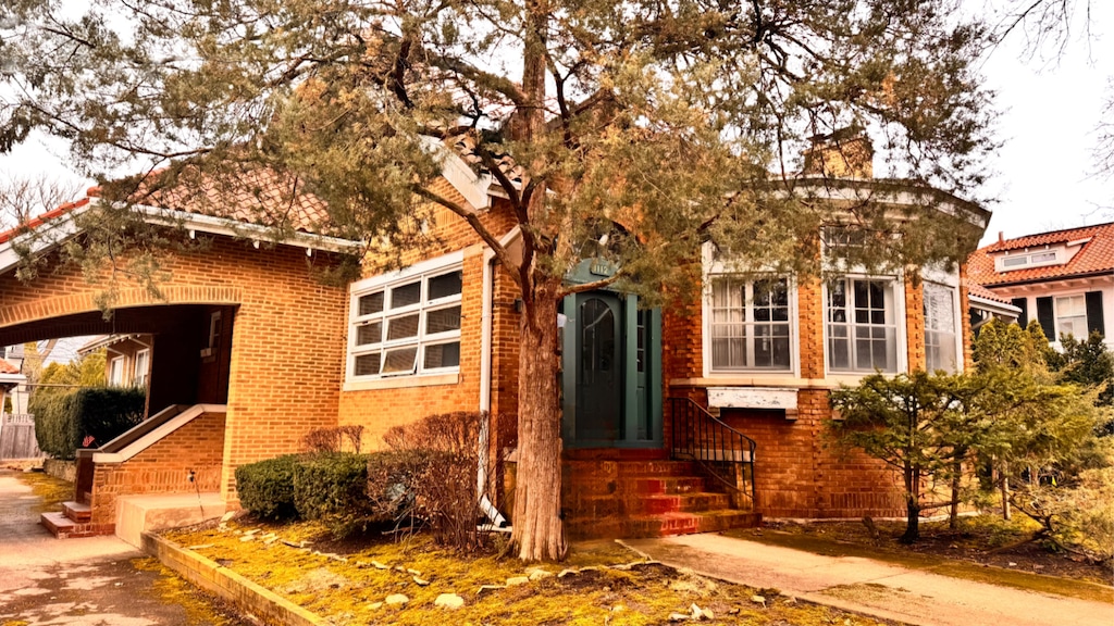 1112 Sheridan Rd, Wilmette, IL 60091 - view of front of house with brick siding and a chimney