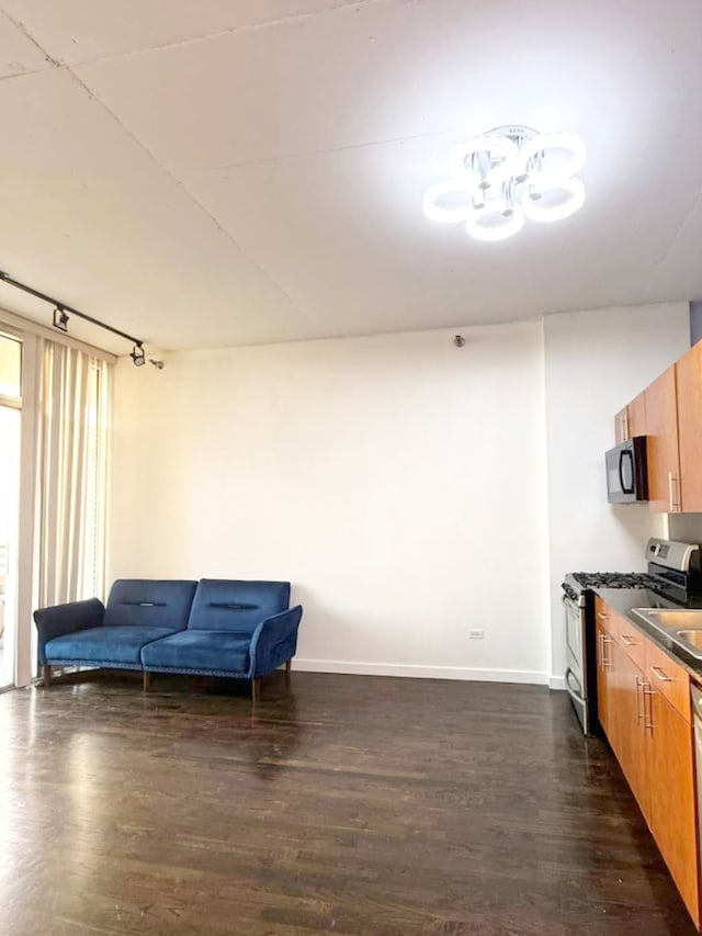 1720 S Michigan Ave Unit 1711, Chicago, IL 60616 - kitchen with gas stove, black microwave, dark wood-type flooring, dark countertops, and baseboards