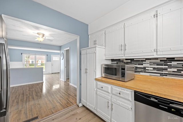 440 Berkshire Ave, Romeoville, IL 60446 - kitchen with stainless steel appliances, decorative backsplash, light wood-style flooring, white cabinets, and light countertops