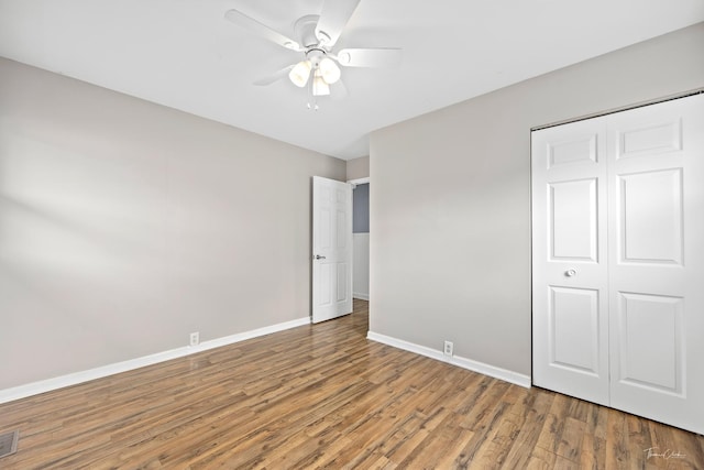 440 Berkshire Ave, Romeoville, IL 60446 - unfurnished bedroom with wood finished floors, baseboards, a closet, and a ceiling fan