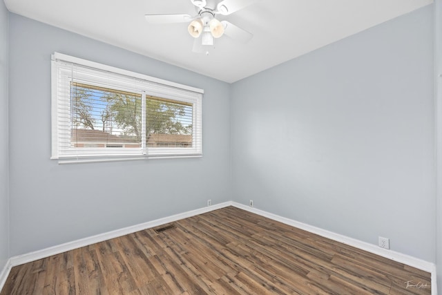 440 Berkshire Ave, Romeoville, IL 60446 - unfurnished room with baseboards, dark wood-type flooring, and a ceiling fan
