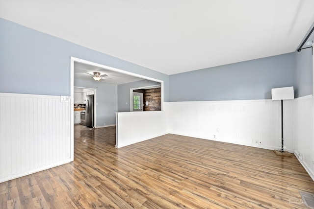 440 Berkshire Ave, Romeoville, IL 60446 - unfurnished room featuring wainscoting and wood finished floors