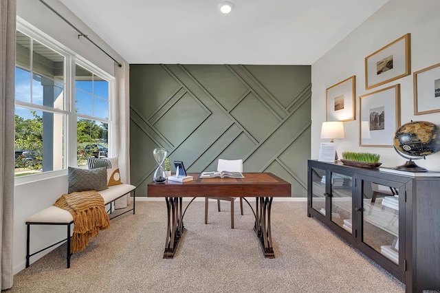 office featuring a decorative wall, carpet, and baseboards