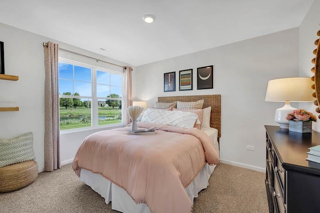 bedroom featuring light carpet and baseboards