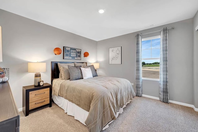 bedroom featuring light carpet and baseboards