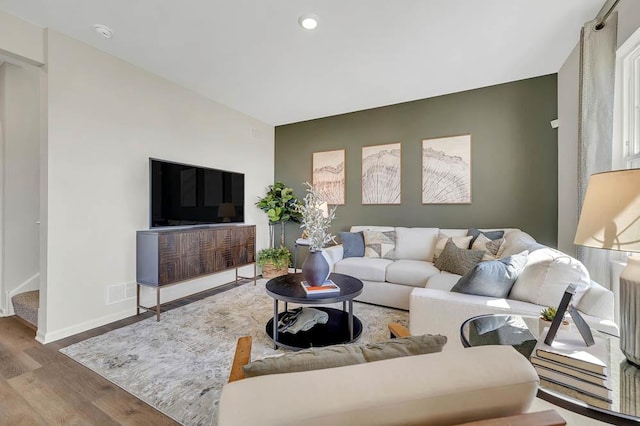 living area with wood finished floors, baseboards, and recessed lighting
