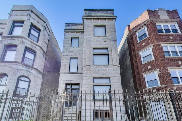 3304 W Warren Blvd, Chicago, IL 60624 - view of front facade with a fenced front yard, a gate, and stone siding