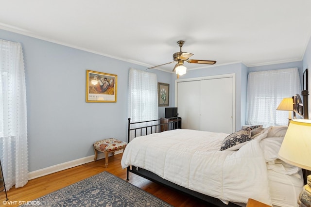 5530 Theobald Rd, Morton Grove, IL 60053 - bedroom featuring crown molding, a closet, wood finished floors, baseboards, and a ceiling fan