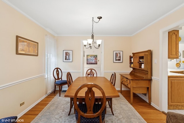 5530 Theobald Rd, Morton Grove, IL 60053 - dining area with a chandelier, light wood-style floors, crown molding, and baseboards