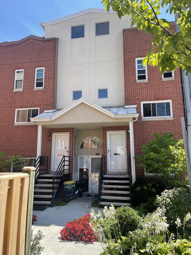 townhome / multi-family property with brick siding