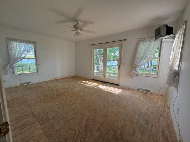 110 Martin Dr, Rock Falls, IL 61071 - unfurnished room featuring healthy amount of natural light, a ceiling fan, and a wall mounted air conditioner