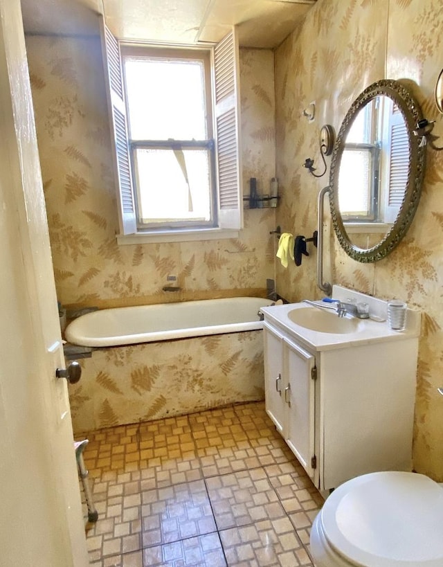 4943 W Monroe St, Chicago, IL 60644 - full bath featuring wallpapered walls, plenty of natural light, a bath, vanity, and toilet