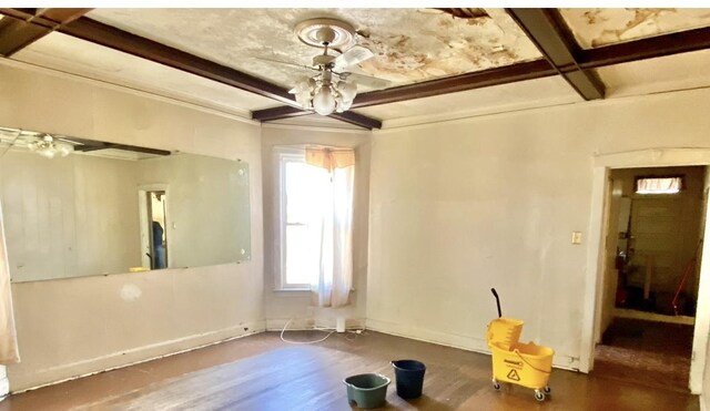 4943 W Monroe St, Chicago, IL 60644 - empty room featuring beam ceiling, wood finished floors, and baseboards