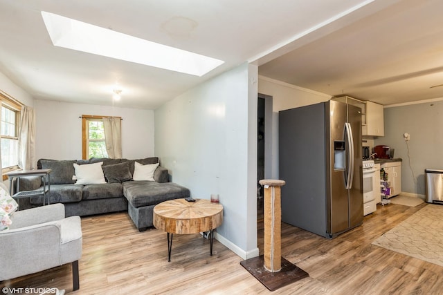 10 S Hickory Ave, Fox Lake, IL 60020 - living room featuring a skylight, light wood-style flooring, and baseboards