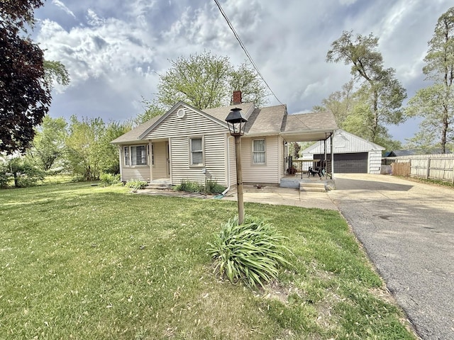 1010 Brentwood Rd, Machesney Park, IL 61115 - view of front facade with a chimney, a garage, and an outbuilding