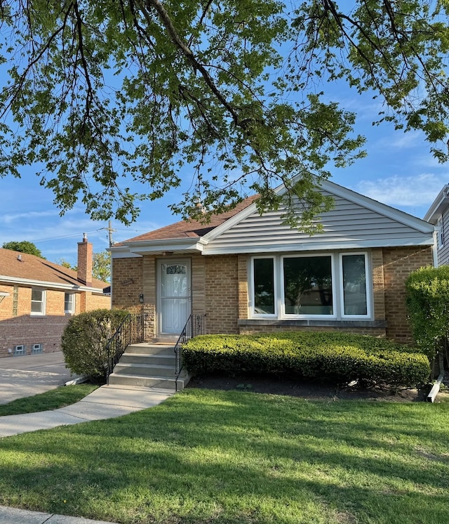7727 W Palatine Ave, Chicago, IL 60631 - view of front of property featuring brick siding and a front yard