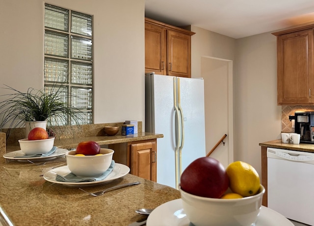 7727 W Palatine Ave, Chicago, IL 60631 - kitchen featuring white appliances, brown cabinetry, and backsplash