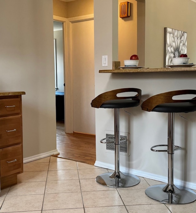 7727 W Palatine Ave, Chicago, IL 60631 - bar with light tile patterned flooring and baseboards