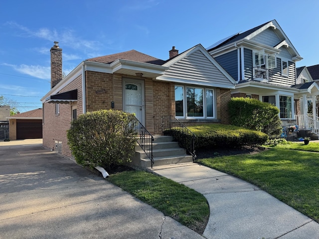 7727 W Palatine Ave, Chicago, IL 60631 - view of front of property featuring a chimney, brick siding, an outbuilding, and a front lawn