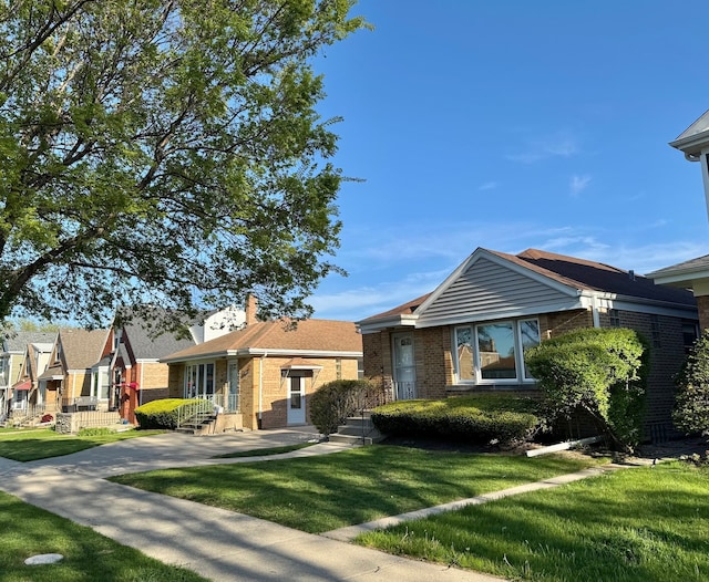 7727 W Palatine Ave, Chicago, IL 60631 - view of front facade featuring brick siding and a front lawn
