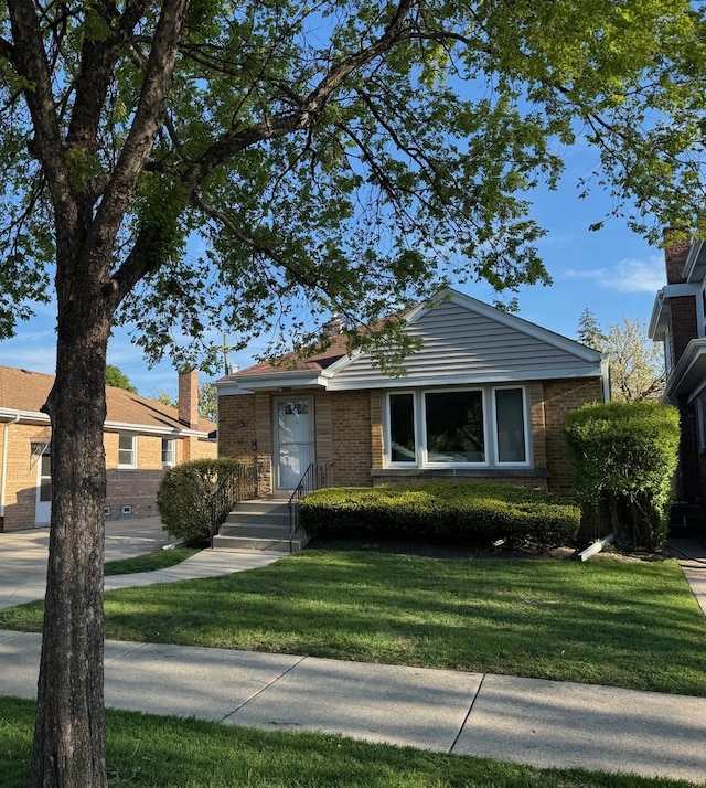 7727 W Palatine Ave, Chicago, IL 60631 - view of front of property featuring brick siding and a front yard