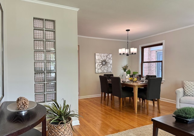 7727 W Palatine Ave, Chicago, IL 60631 - dining room featuring light wood finished floors, ornamental molding, a chandelier, and baseboards