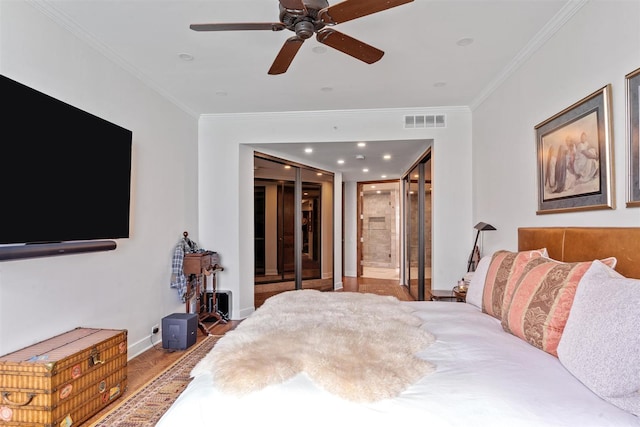 bedroom featuring crown molding, wood finished floors, baseboards, ensuite bathroom, and recessed lighting