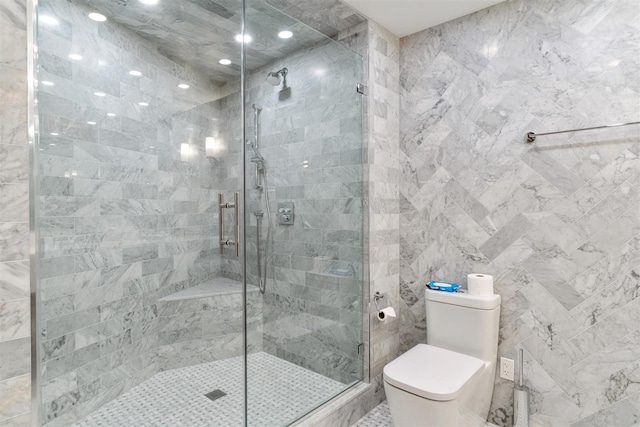 bathroom with a shower stall, toilet, and recessed lighting