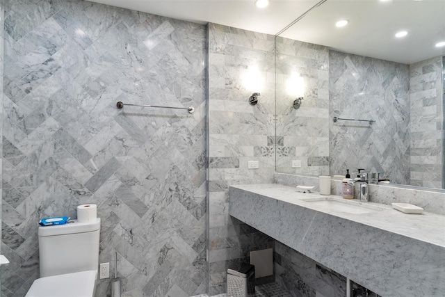 bathroom featuring tile walls, recessed lighting, toilet, and vanity