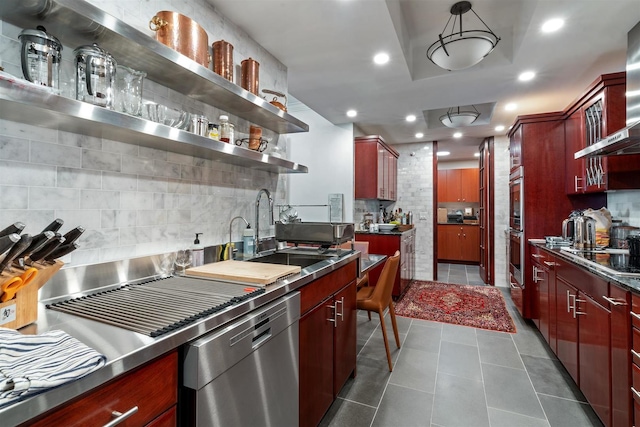 kitchen with stainless steel dishwasher, dark brown cabinets, a sink, decorative backsplash, and recessed lighting