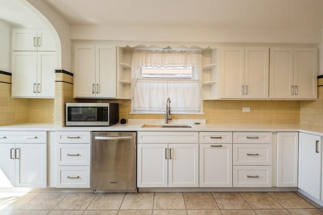 6504 N Artesian Ave, Chicago, IL 60645 - kitchen with appliances with stainless steel finishes, open shelves, a sink, and light countertops