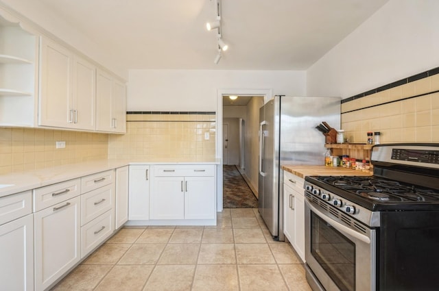6504 N Artesian Ave, Chicago, IL 60645 - kitchen featuring appliances with stainless steel finishes, open shelves, white cabinets, backsplash, and light tile patterned floors