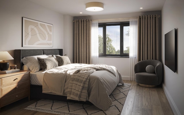 bedroom featuring wood finished floors, baseboards, and recessed lighting