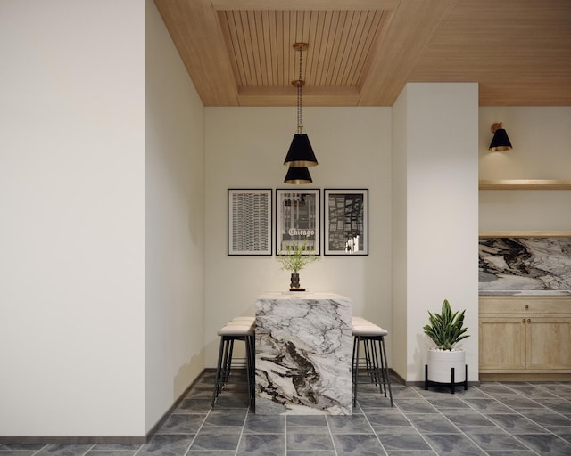 dining space featuring wood ceiling, dark marble finish flooring, and baseboards