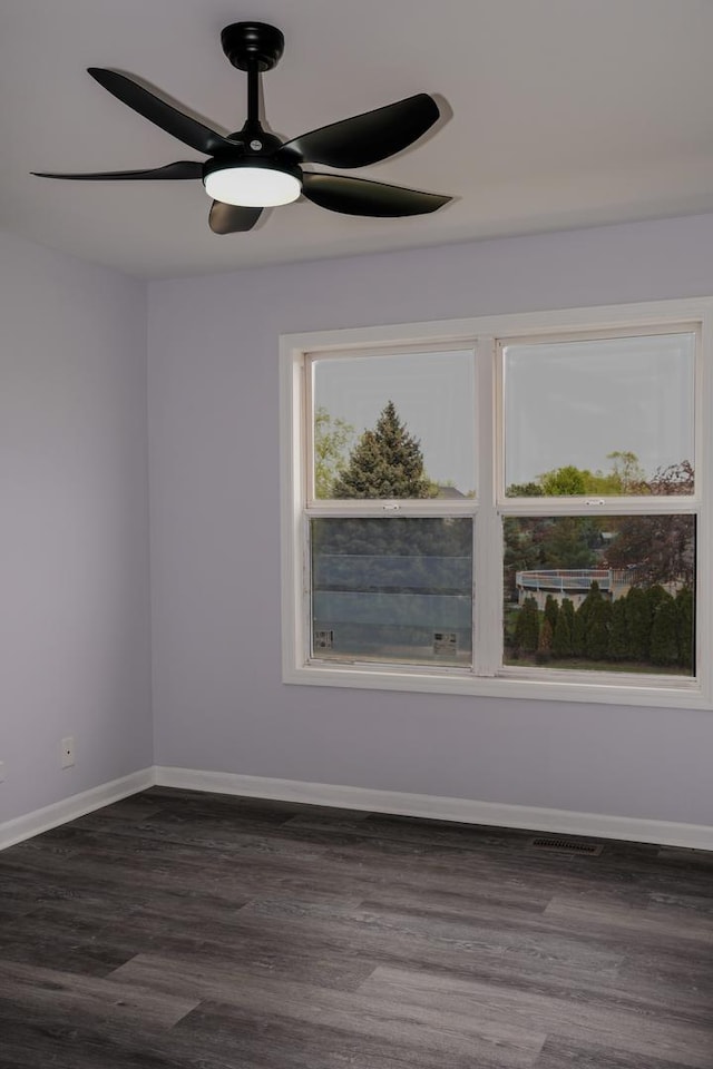 13636 Savanna Dr, Plainfield, IL 60544 - empty room with dark wood-style flooring, baseboards, and a ceiling fan